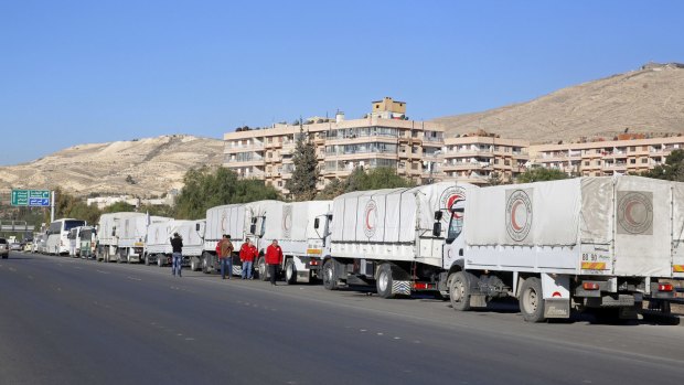 A convoy of humanitarian aid waits in front of the United Nations Relief and Works Agency offices before making its way into the government-besieged rebel-held towns of Madaya, al-Zabadani and al-Moadhamiya in the Damascus countryside on Wednesday.