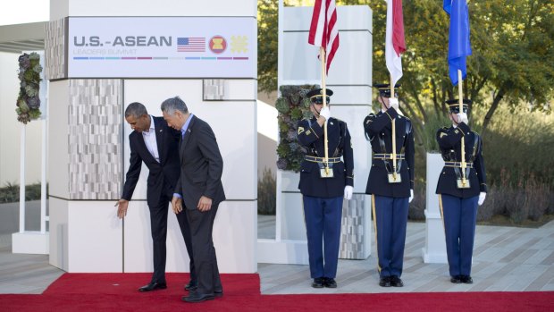 President Barack Obama, left, points to where Singapore Prime Minister Lee Hsien Loong, center, should stand, at a meeting of ASEAN.