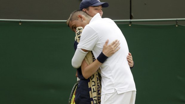 Nick Kyrgios of Australia hugs a ball boy during his match.