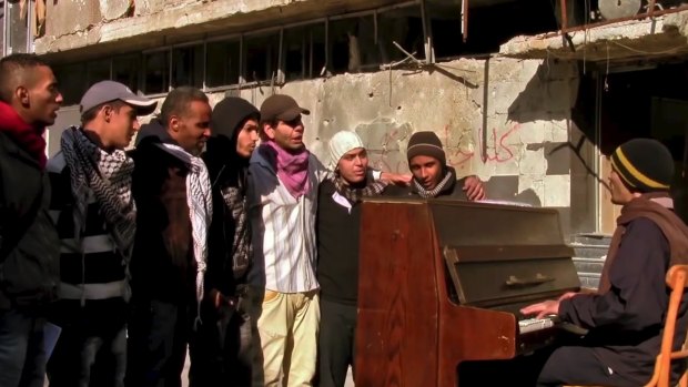 Ayham al-Ahmed rehearsing a song on a rooftop in Yarmouk refugee camp in a scene from the film <i>Blue</i>.