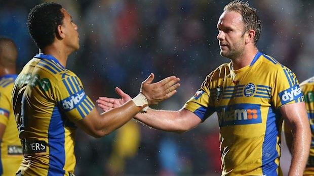 Big upset: Will Hopoate and David Gower of the Eels celebrate victory at Brookvale. 