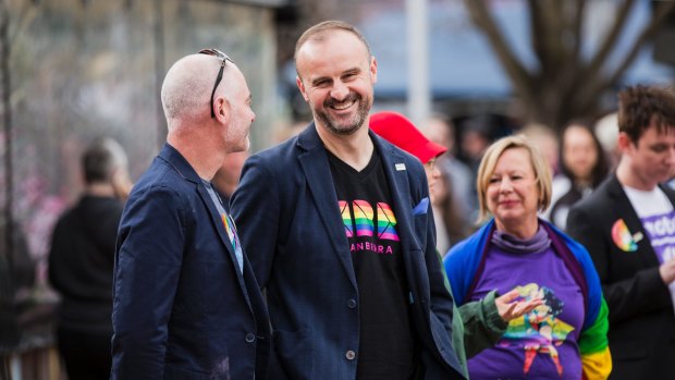 ACT Chief Minister Andrew Barr (with partner Anthony Toms) in one of the new CBR T-shirts.