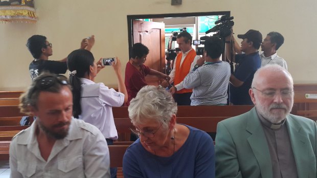 David Taylor's parents
and brother in the front row of Denpasar District Court as David Taylor enters the courtroom.
