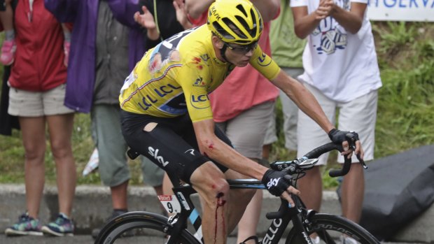 Britain's Chris Froome bleeds from his elbow and knee after crashing during stage 19.