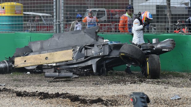 Fernando Alonso emerges from the wreck of his car after he collided with Esteban Gutierrez.