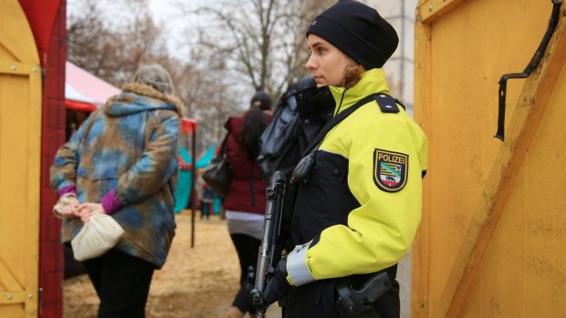 A police officer guards the entrance to a Christmas market in Magdeburg, Germany.