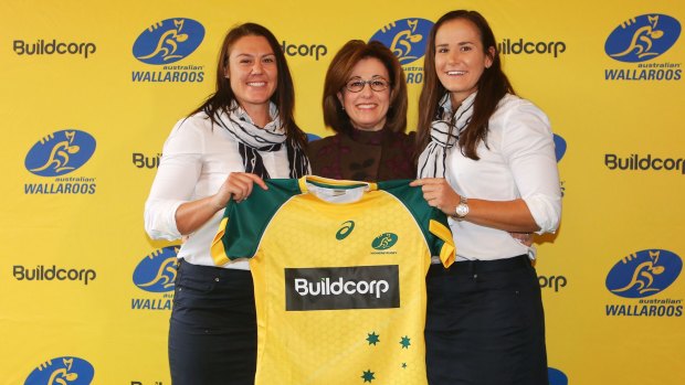 Wallaroos stars Sharni Williams (left) and Shannon Parry (right) celebrate their new sponsorship deal with Buildcorp's Josephine Sukkar.
