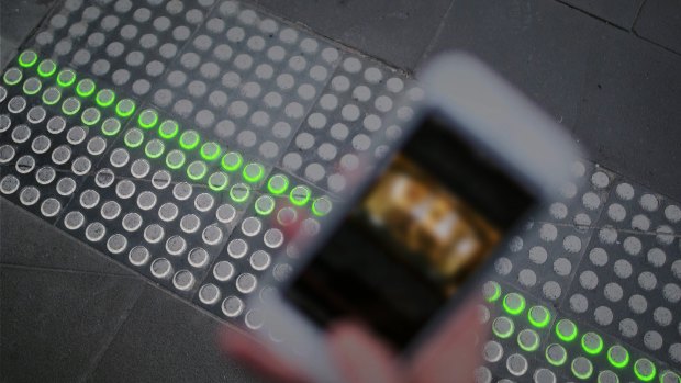 A smartphone user gets the green light from Buro North's Smart Tactile Paving.