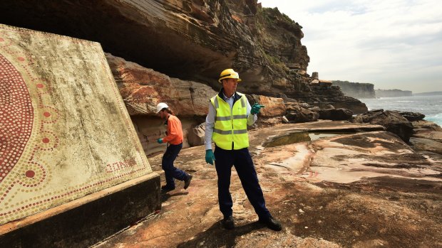 Bondi Waste Water Treatment Plant Manager Tony Williamson (right) and Production Team Leader Daniel Toole by the mural  painted anonymously two years ago on the side wall of the plant's safety escape that opens onto the ocean at North Bondi. 