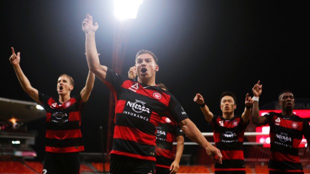 On point: Brendon Santalab leads the Wanderers' celebrations in front Western Sydney fans after their round one win against Perth Glory.