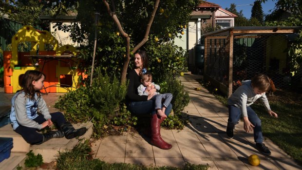 Liz Slakey with her children Luca Slakey 8 (left), Pippi Slakey 2 (2nd from right) and Declan Slakey 5 (right) in the backyard of their Haberfield home they are set to lose.
