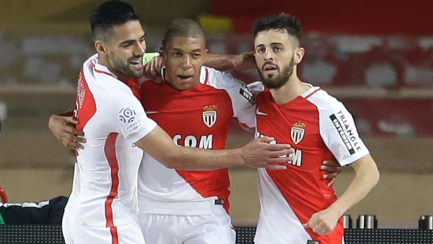 Monaco's Bernardo Silva (right) celebrates with teammates Kylian MBappe (centre), who is also being chased, and Radamel Falcao.