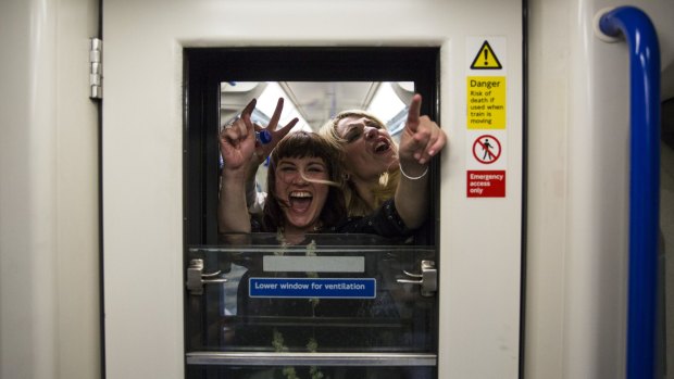 Revelers in a carriage on the Victoria line.