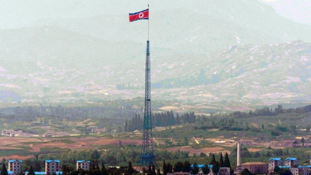 A giant North Korean flag flutters on the top of a 160-meter tower in North Korea.