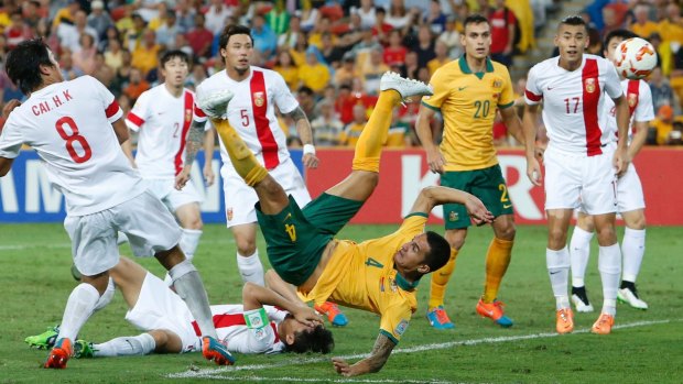 Tim Cahill scores from an overhead kick during the Asian Cup quarter-final against China.
 