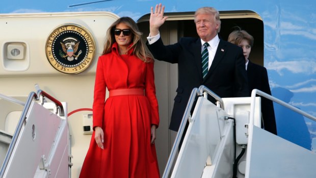 President Donald Trump waves from Air Force One with First Lady Melania.
