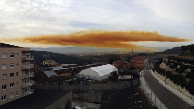 An orange toxic cloud is seen over the town of Igualada.