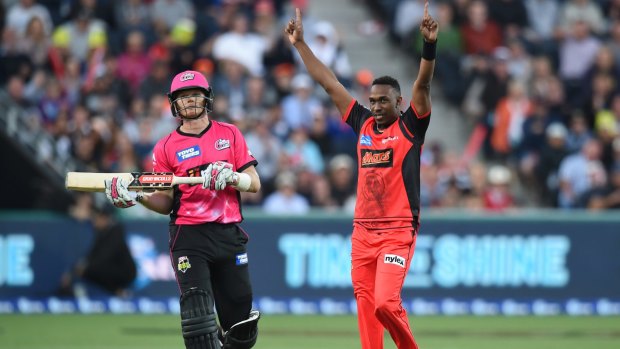 Too good: Dwayne Bravo of the Renegades (right) celebrates the wicket of Sam Billings of the Sixers.