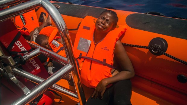 A woman cries after being rescued by aid workers from Spanish NGO Proactiva Open Arms in the Mediterranean Sea, about 24 kilometres north of Sabratha, Libya, on Tuesday.