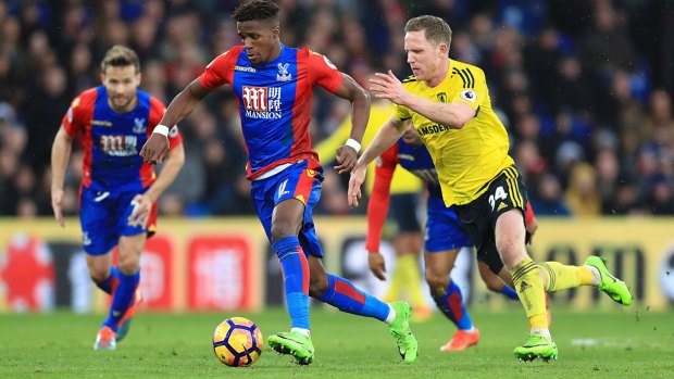 Crystal Palace's Wilfried Zaha wins the ball from  Middlesbrough's Adam Forshaw.