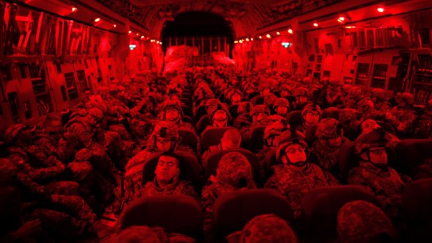 Soldiers in full gear on a C-17 military transport from Manas Air Force Base in Kyrgyzstan to Mazar-i-Sharif, Afghanistan,  in 2010.