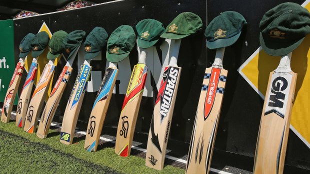 The bats and caps of the Australian cricket team are left by the field in a tribute to the late Phillip Hughes