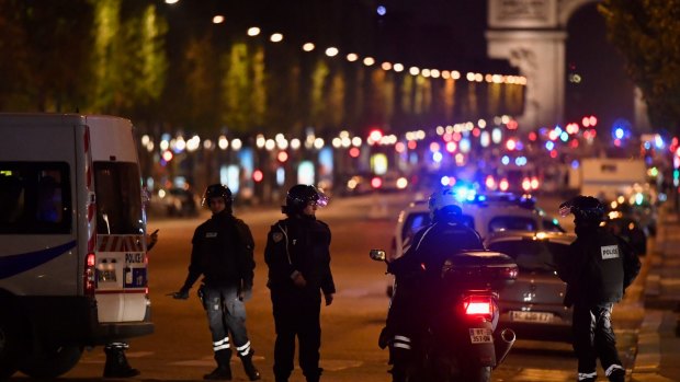 Police officers secure the area after a gunman opened fire on Champs Elysees.