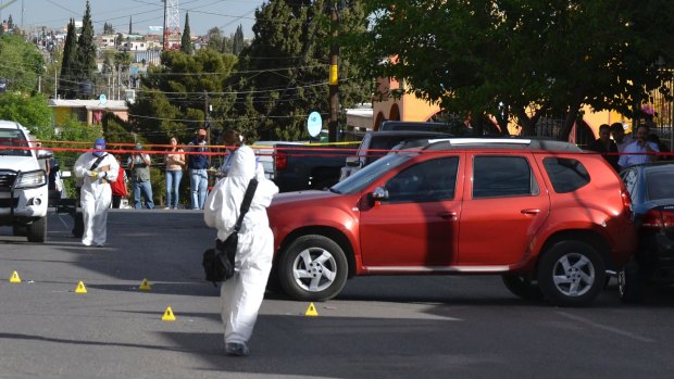 Forensic workers on the scene where journalist Miroslava Breach was shot and killed outside her home in Chihuahua, Mexico.