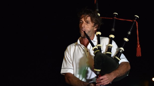 A lone piper performs during a remembrance ceremony for the late Australian batsman Phillip Hughes in Macksville,