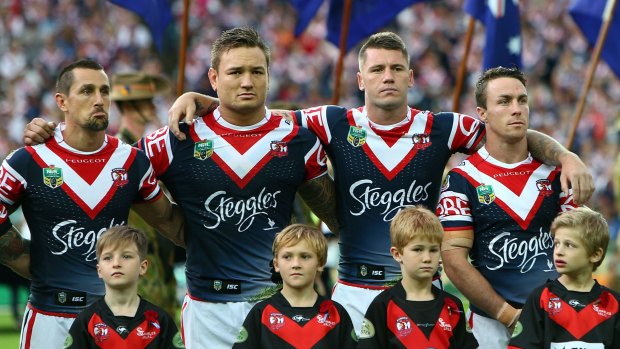 Solemn: Roosters players before the Anzac Day match last year.