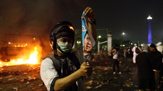 A protester with a rolled up poster.