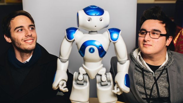 Connor Costanzo and Christopher Goddard with Leo the robot at Caroline Chisholm School. They are part of a team that has programmed the robot to help children with autism.