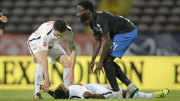 Dinamo's Patrick Ekeng lies on the pitch after collapsing during a league game in Bucharest, Romania.