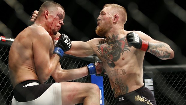 Conor McGregor, right, trades punches with Nate Diaz during his losing UFC 196 welterweight mixed martial arts match in Las Vegas. 