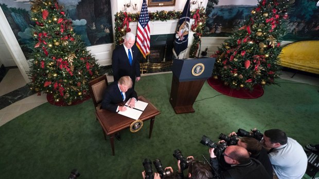 US President Donald Trump signs the proclamation recognising Jerusalem as the capital of Israel.
