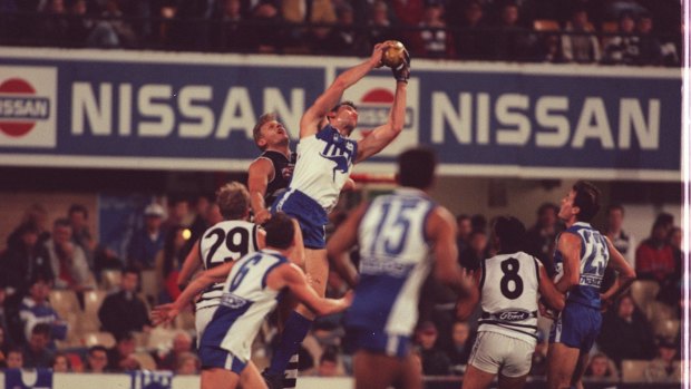 Towering: Wayne Carey flies for a mark during the Kangaroos' foray into Sydney in 1999.