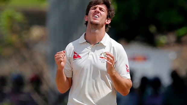 Caught in the middle: Mitchell Marsh.