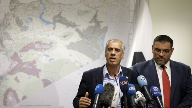 The National Coalition of the Syrian Revolution's "prime minister", Jawad Abu Hatab, left, speaks next to coalition president Anas Abdah in Istanbul on Monday. Abdah hailed the breaching of the Syrian government siege in Aleppo as "miraculous''.
