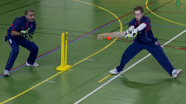 French cricket team practising indoors during winter.
