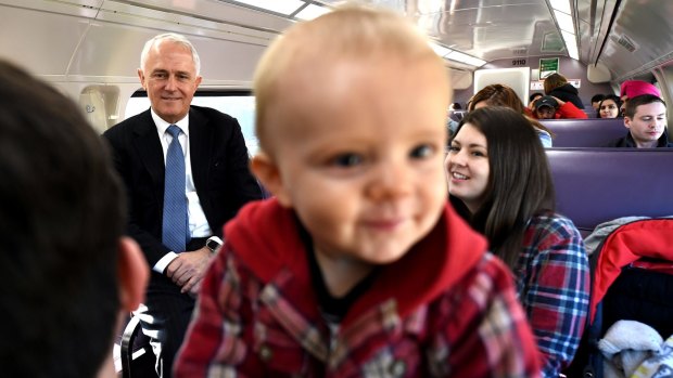 Prime Minister Malcolm Turnbull meets Ryan and Angel Johnson and their son Clark  on the train to Emu Plains in the marginal seat of Lindsay.
