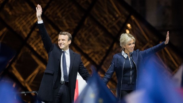 Emmanuel Macron, French presidential candidate, and his wife wife Brigitte Trogneux, wave after delivering a speech in front of the Pyramid at the Louvre Museum in Paris.