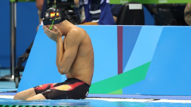 Spain's Miguel Duran Navia cries after tumbling into the pool before his heat. 