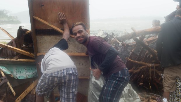 Port Vila residents survey the damage.