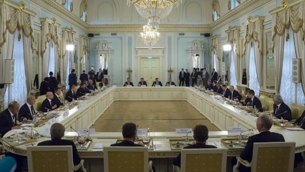 Russian President Vladimir Putin, fifth right, and Turkish President Recep Tayyip Erdogan, fifth left, attend a meeting with Turkish and Russian businessmen in the Konstantin palace.