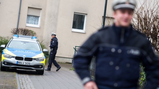 Police officers in front of a house in Duesseldorf, where a German magazine says two people with possible links to the Brussels attacks were arrested on Friday.