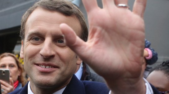 Centrist candidate Emmanuel Macron waves to supporters.