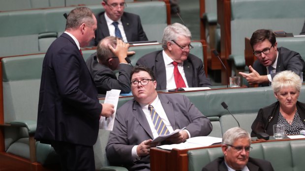 Deputy Prime Minister Barnaby Joyce speaks with George Christensen during question time at Parliament House in Canberra on Tuesday.