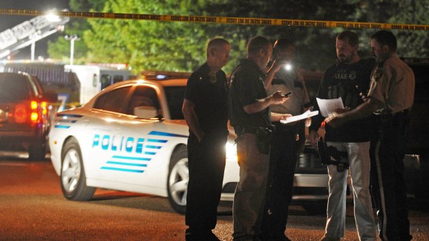 Hattiesburg police officers study information about the suspects wanted for the fatal shooting of two of their colleagues.