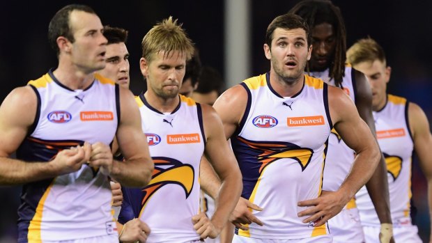 The dejected Eagles trudge off Etihad Stadium after tight loss to Western Bulldogs