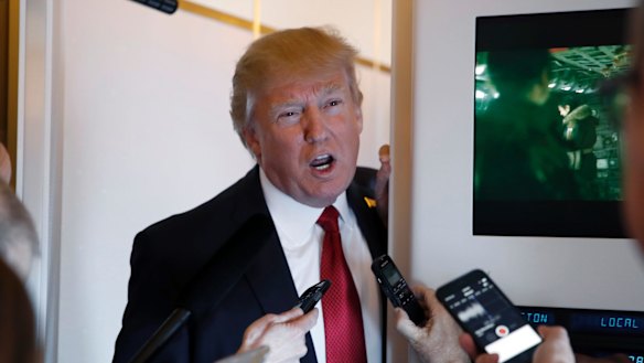 President Donald Trump speaks with reporters on Air Force One 